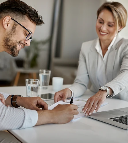happy-man-his-wife-having-meeting-with-financial-advisor-signing-agreement-office